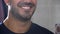 Close-up smiling face of handsome young bearded man. Close up of perfect male teeth. Closeup shot of awesome healthy