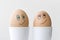 Close up of smiling faces drawn on two boiled eggs, love happiness relationship concept