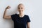 Close up smiling hairless woman showing strength, struggling with cancer
