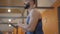 Close-up of smiling Middle Eastern man running on treadmill in gym. Side view portrait of handsome black-haired