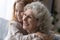 Close up smiling pretty little girl hugging mature grandmother