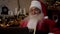 Close up smiling Santa Claus greets talks to children online laptop video call