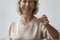 Close up of smiling senior woman holding house keys