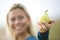 Close-up of smiling woman holding a pear