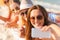 Close up of smiling women with smartphone on beach