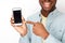 Close up smiling young black man pointing to cellphone screen