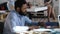 Close-up smiling young positive black manager man talking to business partner sitting at trendy modern loft office table