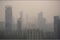 close-up of smoggy city skyline, with the tall buildings fading into the haze