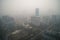 close-up of smoggy city skyline, with tall buildings obscured by toxic haze