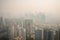 close-up of smoggy city skyline, with tall buildings obscured by toxic haze