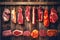 Close-up of smoked or cured meat. Dry-cured meat and ham suspended on a rope. Fresh meat products. Homemade farm production