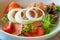 Close up smoked salmon salad with vegetable onion tomato in plate