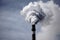 close-up of smokestack, with smoke and fumes billowing out