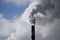 close-up of smokestack, with smoke and fumes billowing out