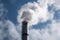 close-up of smokestack, with smoke and fumes billowing out