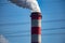 A close-up of the smoking chimneys of a coal-fired power plant.