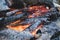 Close-up of a smoldering fireplace in barbecue near picnic table