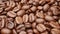 Close-up, smooth moving roasted coffee beans