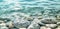 Close-up of smooth white pebbles submerged in clear water