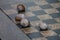 a Close-up of snail shells lying on a chess board in the garden