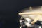 Close-up, snare drum and drumsticks on a dark background.