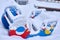 Close up of a snow covered boat shaped seesaw teeter totter in a children play park during the cold winter season