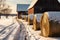 close-up of snow-covered hay bales near barn