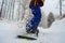 Close-up of a snowboard is glides with snow splashes