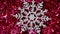 A close-up snowflake lies on New Year`s red tinsel and slowly moves clockwise. Christmas winter background. Happy New Year