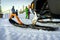 Close-up of a snowy runners of a snowmobile