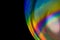 Close-up soap bubble, like rainbow spectrum reflection from lens on dark background. Abstract multicolor psychedelic alien planet