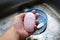 Close up a soap in hand of a man in the kitchen was washing a hands in the sink wash dishes