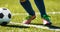 Close up soccer football kick the ball. Feet of footballer running and kicking soccer ball