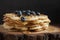 Close-up of soft Viennese waffles with blueberries and honey
