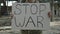 Close up of soldier holding banner with Stop War inscription