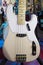 Close up of solid electric bass guitar in vintage antique white