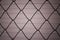 Close up solid metallic wire mesh fence in vintage style.