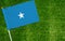 Close-up of Somalia flag against closed up view of grass