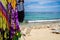 Close up of some colorful fabrics and some white plastic chairs in the sand in San Andres beach, Colombia