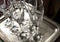 close up of some empty glass wine cups on a silver tray very clean ready to be used at a restaurant in a party