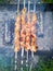 Close up of some grilled meat skewers in a barbecue standing on the grass