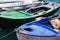 A close up of some small wooden colorful fishing boats at the po