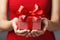 close-up of someone holding a red gift box tied with a ribbon, christmas concept, family concept