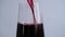 Close-up of a sommelier, a waiter pours red wine, juice or champagne into a glass glass. Alcohol in a glass. 4K video