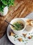 Close-up of soup in a glass. Takeaway food in disposable dishes. A paper cup with a hodgepodge, mushroom soup and croutons. The