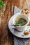 Close-up of soup in a glass. Takeaway food in disposable dishes. A paper cup with a hodgepodge, mushroom soup and croutons. The