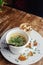 Close-up of soup in a glass. Takeaway food in disposable dishes. A paper cup with a hodgepodge, mushroom soup and croutons. The