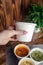 Close-up of soup in a glass. Takeaway food in disposable dishes. A paper cup with a hodgepodge, mushroom soup and croutons. The