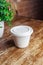 Close-up of soup in a glass. Takeaway food in disposable dishes. A paper cup with a hodgepodge, mushroom soup and croutons. The