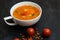 close up on soup with tomato, lentil and potato, rustical background, top view